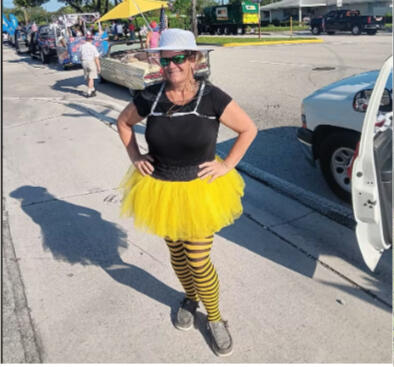 Lady posing in a black and yellow bee outfit